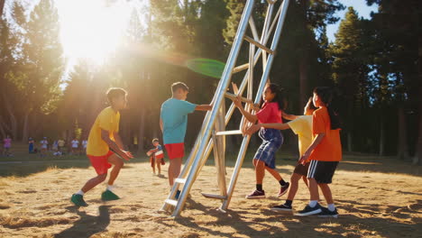children playing and climbing on a metal structure in a sunny outdoor park