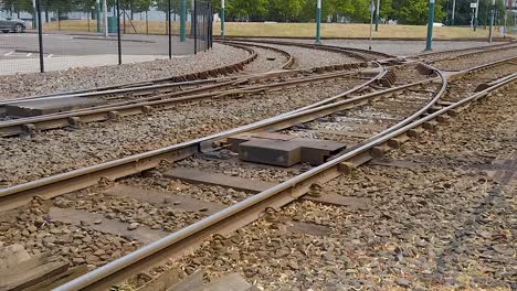 Tram-tracks-curving-at-a-park-and-ride-area-in-the-city-of-Nottingham-in-Nottinghamshire,-England,-United-Kingdom