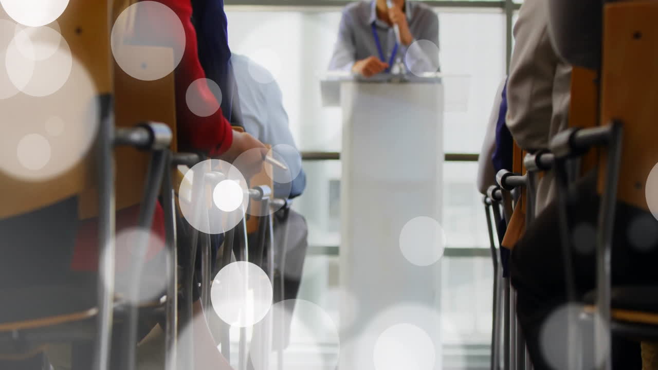 Addressing audience, speaker at podium in conference room with animation effect