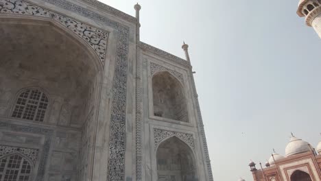 view from minaret to taj mahal abstract decorated grandiose entrance - pan low angle wide shot