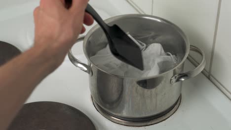 sanitizing used face masks in boiling water