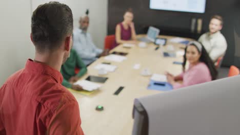 happy diverse business people discussing work during meeting at office