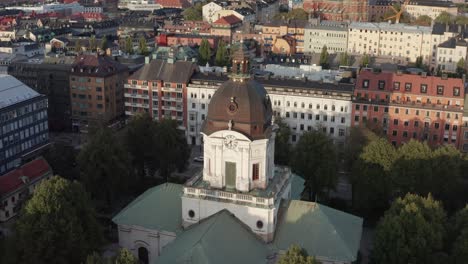 drone shot of adolf fredriks church in stockholm, sweden during sunset in late summer