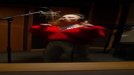 woman singing in a recording studio