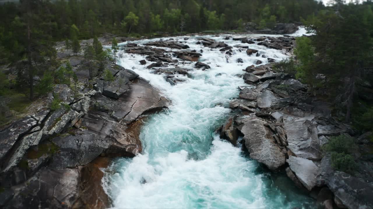 Mesmerizing sight - the powerful flow of wild water rushing in the narrow rocky riverbed, foaming, splashing, forming whirlpools and eddies on its' way