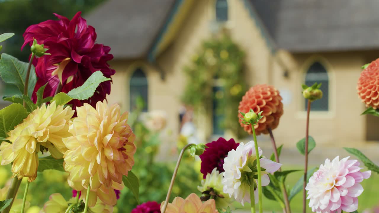 Colorful flowers bloom vibrantly in front of a castle during a spring festival celebration