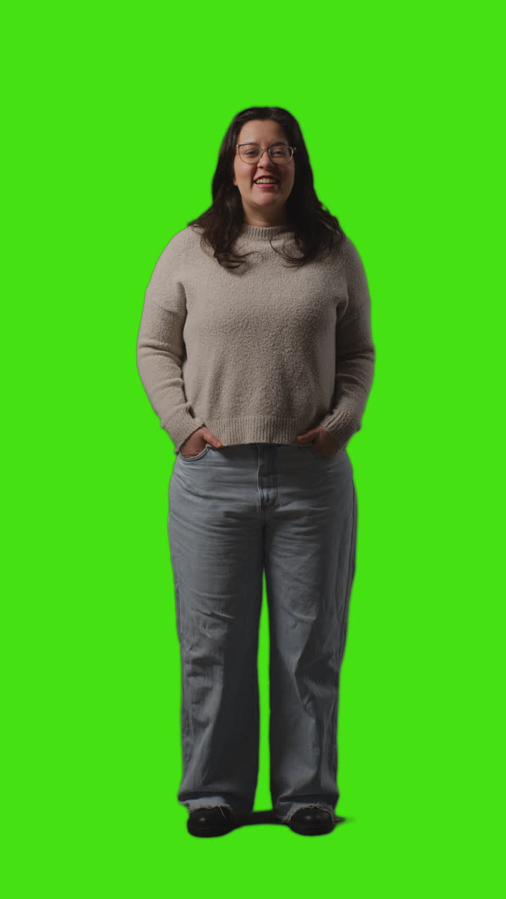Vertical Video Full Length Portrait Shot Of Smiling Casually Dressed Young Woman Standing Against Green Screen 2