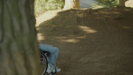 Young-Black-Man-Riding-His-Wheelchair-Outside-On-Summer-Day