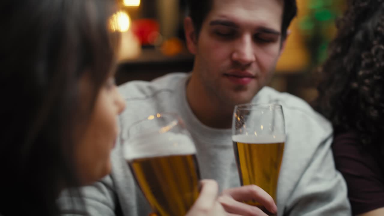 Handheld video of caucasian friends meeting in the pub