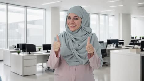 happy muslim businesswoman showing thumbs up