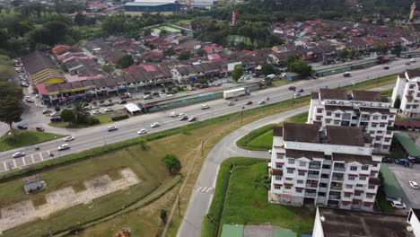 establishing shot at slow pace with a pan tilt down towards the street and shop lots in selangor malaysia