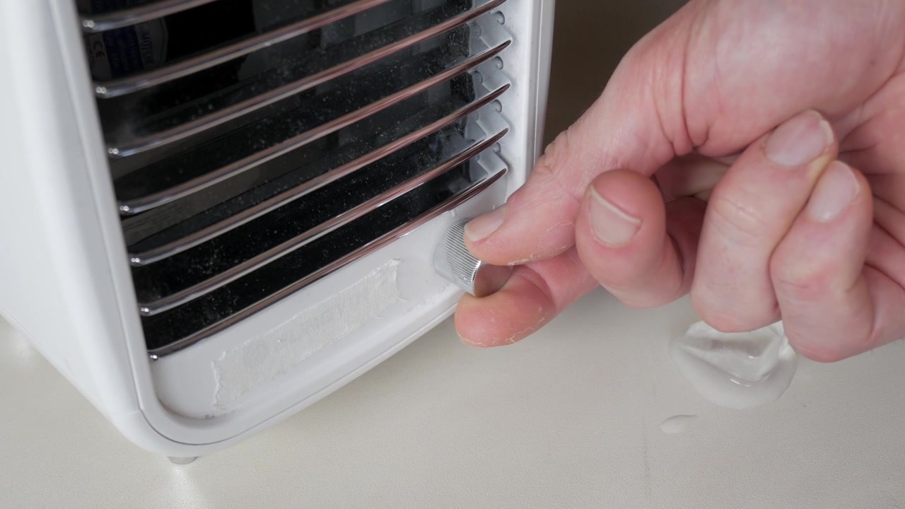 Melting ice cube near white ventilation appliance.