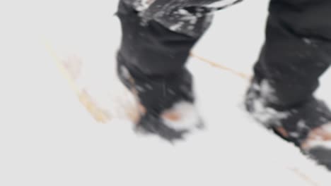 cinematic rough jerky camera action of a man walking in and out of focus in snow shoes in the canadian arctic