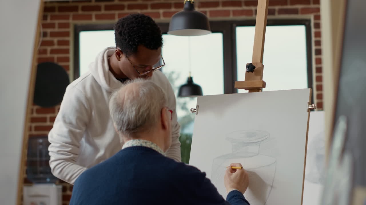 Male artist explaining drawing technique to elder woman