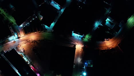 bright night time illumination with traffic in street