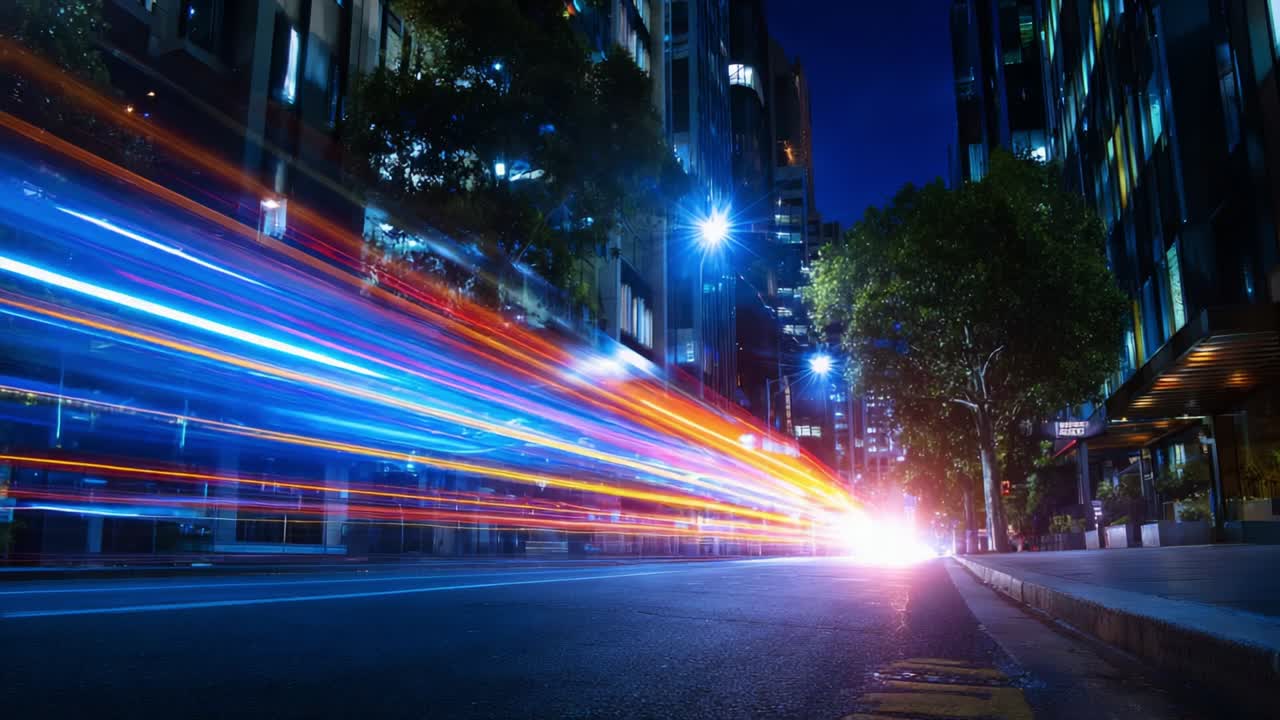 Streaks of Colorful Light Through a City Street at Night Captured in Two Frames Showcasing the Dynamic Movement and Vibrancy of Urban Life with City Lights and Trees in the Background