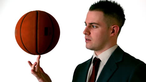 businessman spinning basketball on finger