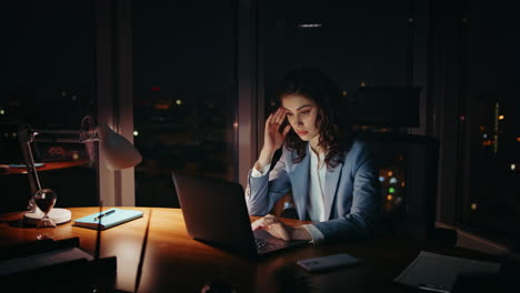 unmotivated woman manager typing laptop feeling sleepy at workplace. tired lady