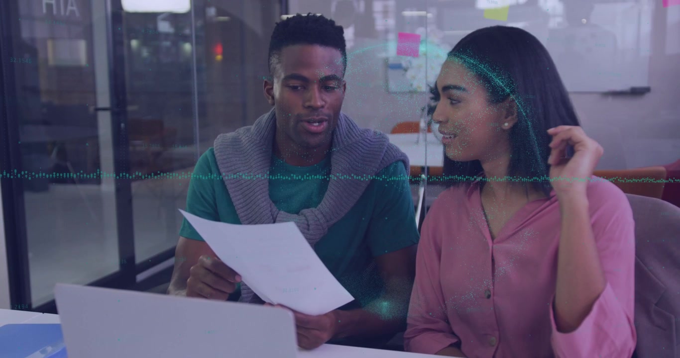 Animation of data processing over diverse man and woman discussing over a document at office