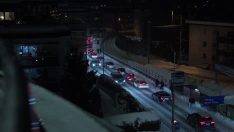 shot of davos high-street showing traffic leaving the resort in the evening after the world economic forum