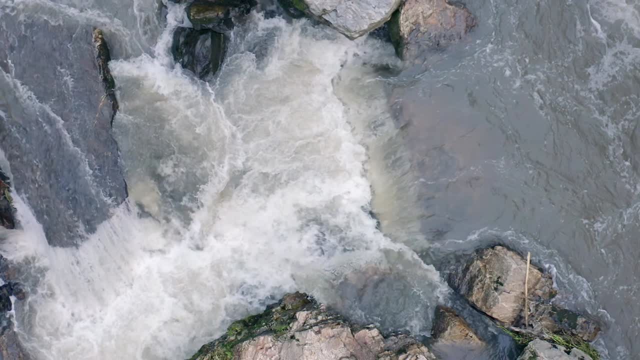 Aerial overhead view of water rapids in slow motion