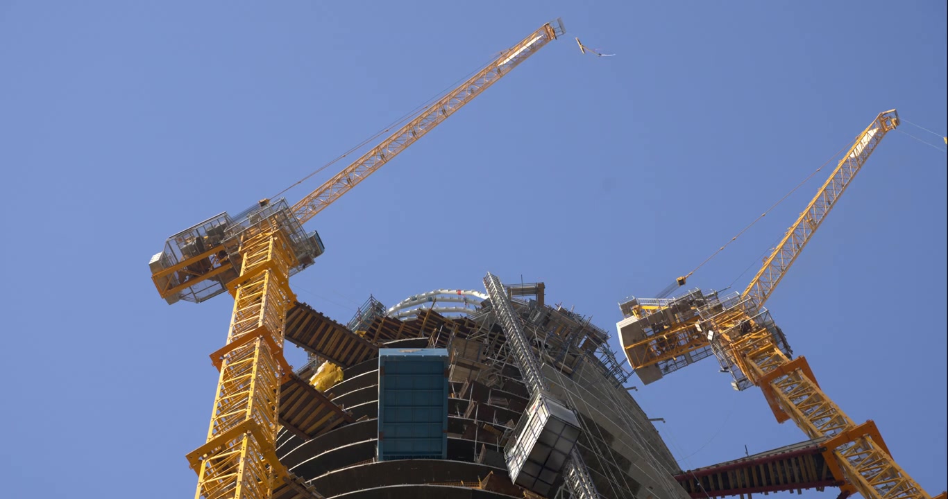 Tower Cranes Working on Skyscraper Construction Site