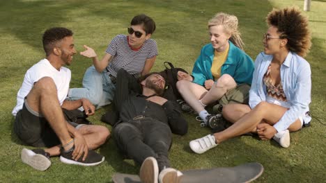 Cool-young-friends-chilling-on-meadow