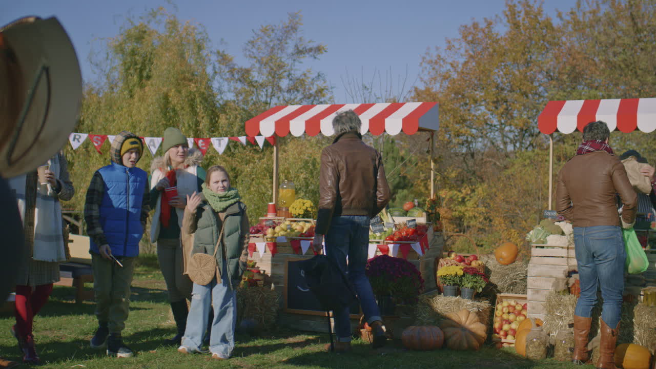 Steakmaster Adds Oil in Grill Steakmaster Adds Oil in Grill Peoples Walking and Shopping on Urban Farmers Market Choosing Fresh Fruits and Vegetables Buying Products to Home Autumn Fair Outdoors