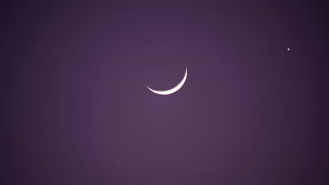 crescent moon and star in purple night sky
