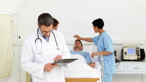 Doctors-and-nurse-watching-over-sick-patient