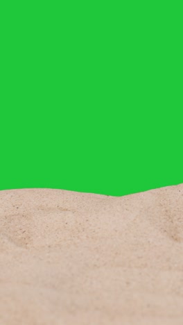 Vertical-Video-Summer-Holiday-Concept-With-Sandy-Beach-In-Foreground-Against-Green-Screen