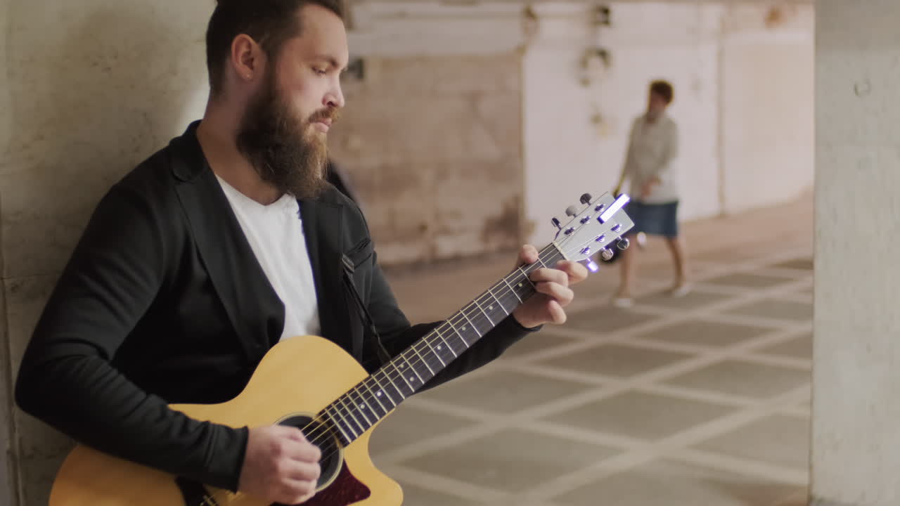 Musician Playing Guitar in Underpass