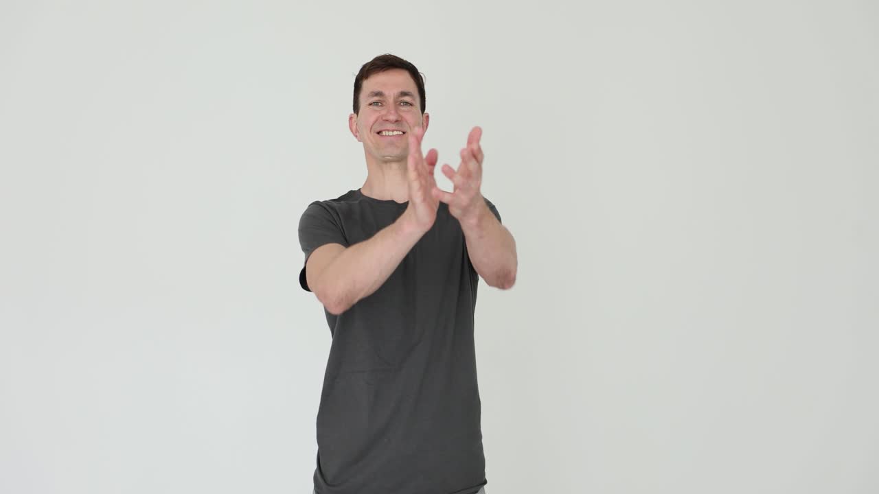 Man clapping in front of a white background