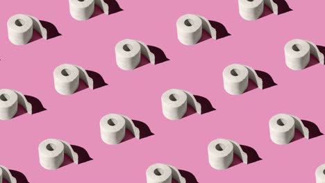 animación de bucle sin costuras con rollos de papel higiénico blanco aislados en un fondo rosado de primer plano. patrón con sombras duras del sol al mediodía
