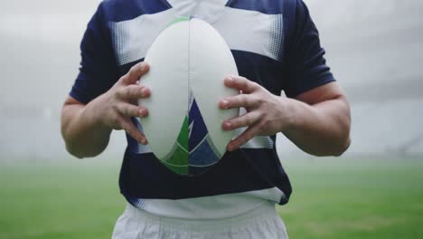 male rugby player holding rugby ball in the stadium 4k