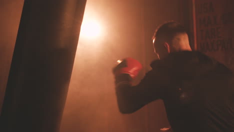 sportsman warms up hitting punching bag