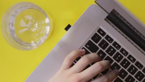 co working space typing blogging on a yellow backdrop