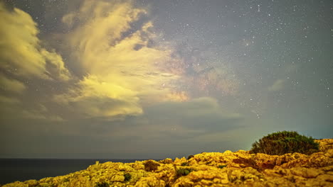 timelapse of storm clouds forming in front of the milkyway over the sea