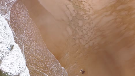 Stunning-Aerial-Shot-of-Waves-Crashing-on-Tynemouth-Long-Sands-Beach