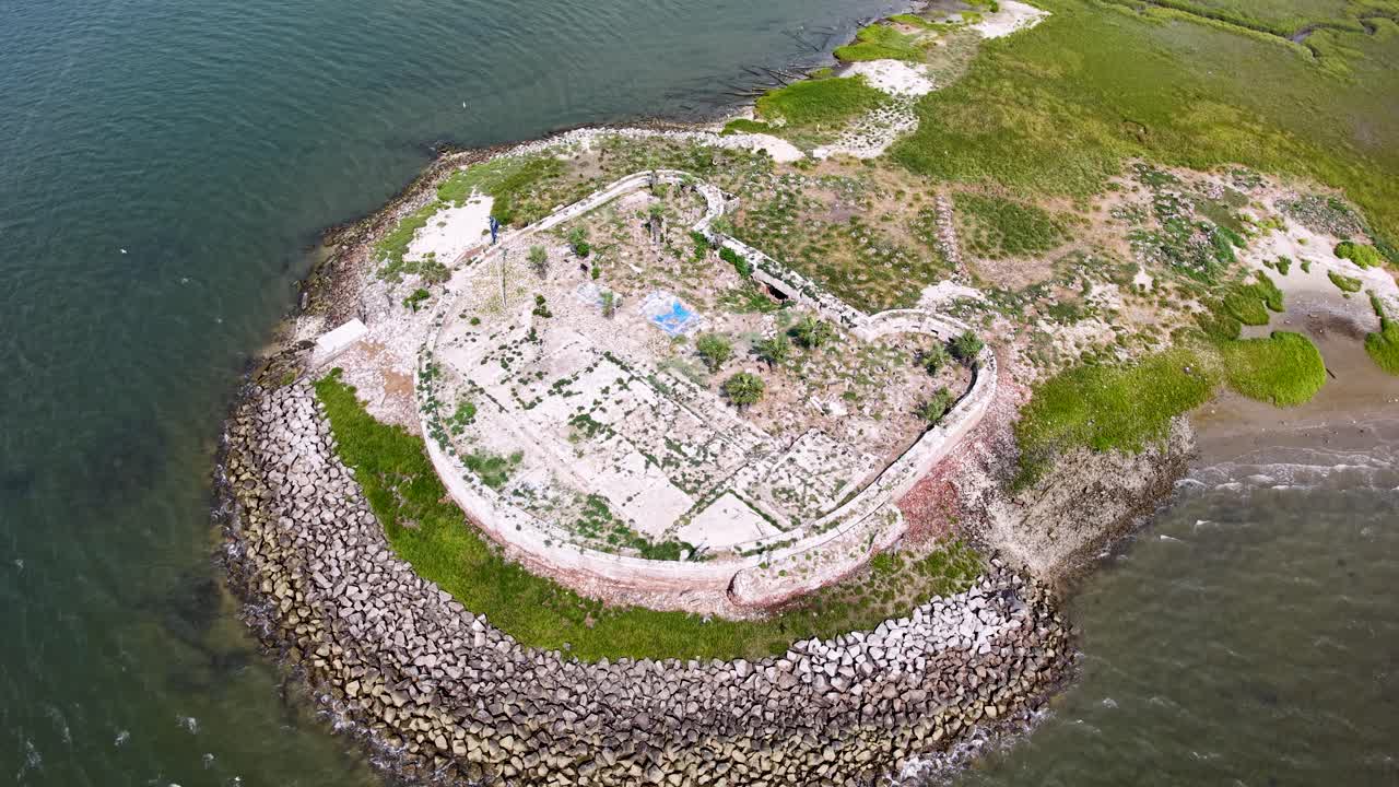Aerial view of Castle Pinckney on Shutes Folly Island, surrounded by the Charleston Harbor waters