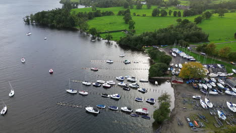 Aerial-footage-of-boatyard-and-several-boats-moored-by-lake