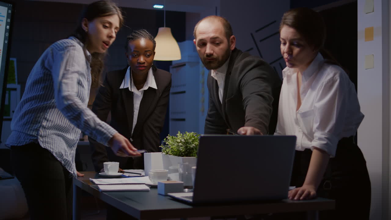 Diverse teamwork checking management presentation on laptop computer