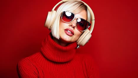 a woman wearing a red sweater and headphones