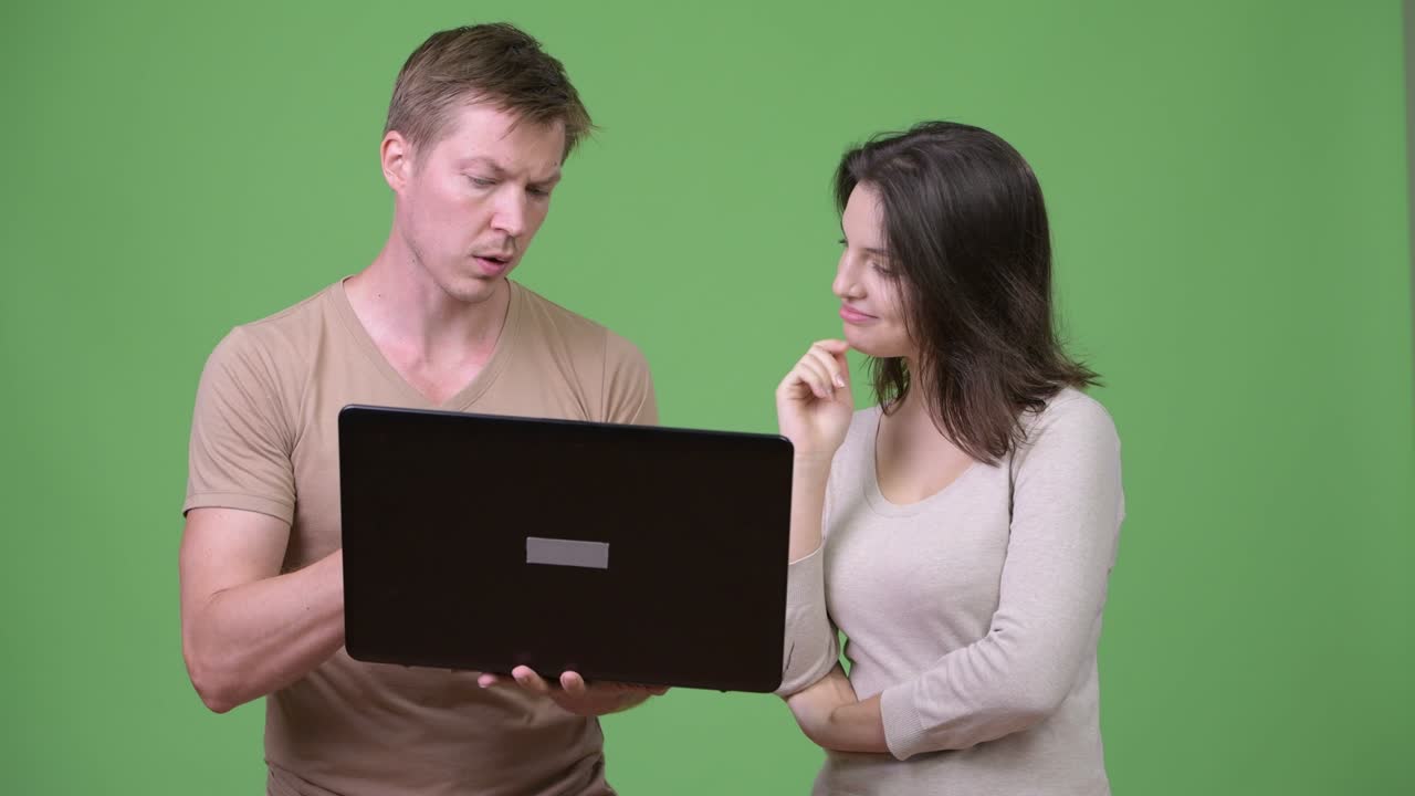 Young couple using laptop and thinking together