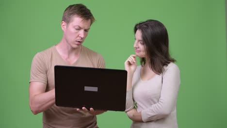 young couple using laptop and thinking together