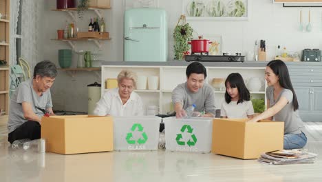 asian family helping to separate plastic bottle into recyclable bin at home together.