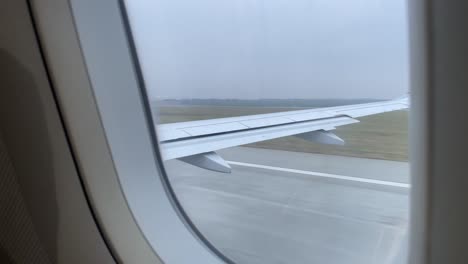 view from an airplane window over airport runway