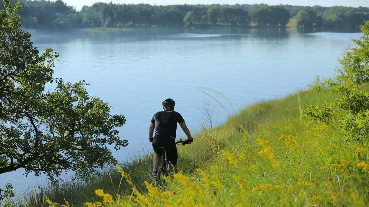 Man Bike On Nature. Active man cyclists bicycle riders in wild nature