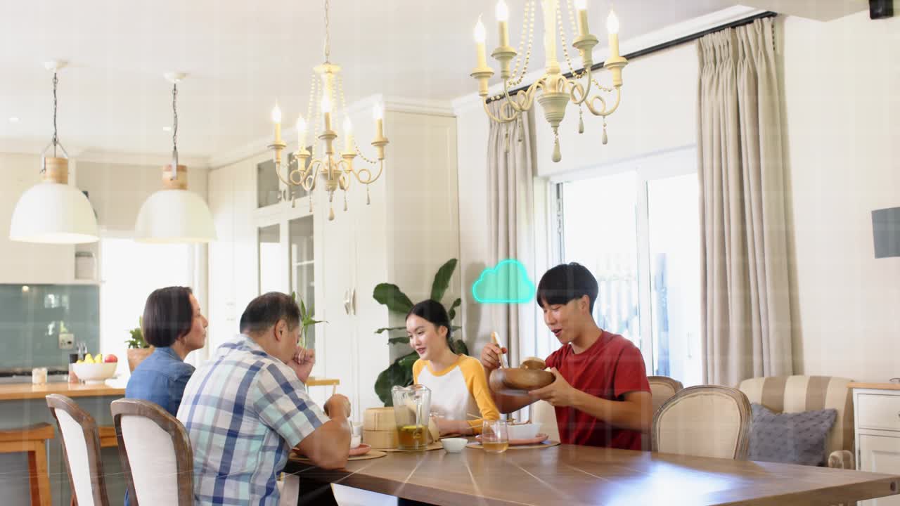 Family chatting around table, green cloud graphics appearing, man in red passing bowl to share food