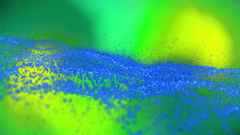 blue particles forming wave patterns, dynamic animation over green and yellow background